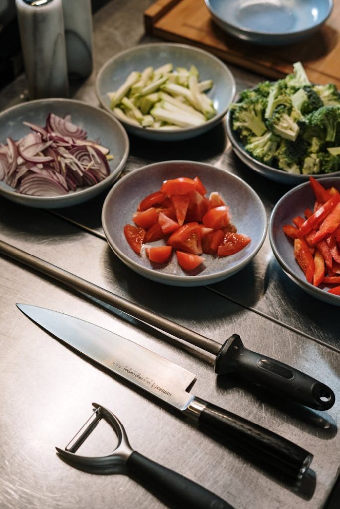 A detailed close-up of fresh vegetables and kitchen tools for cooking.