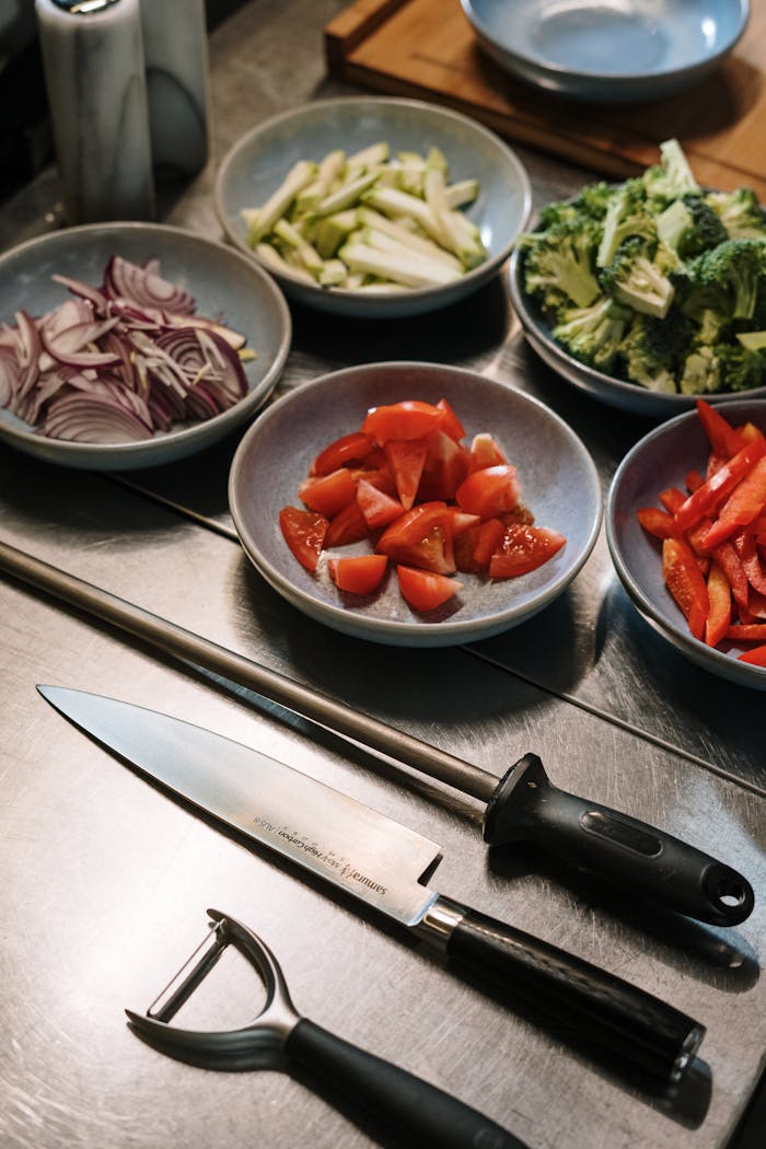 A detailed close-up of fresh vegetables and kitchen tools for cooking.